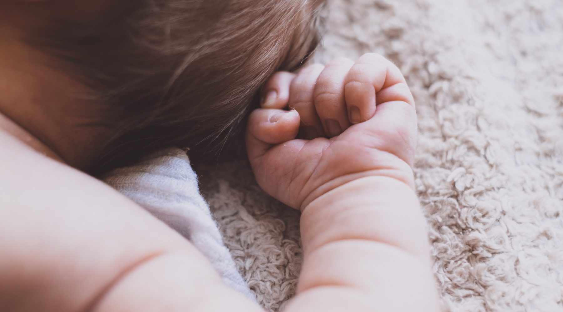 Baby plays on rug