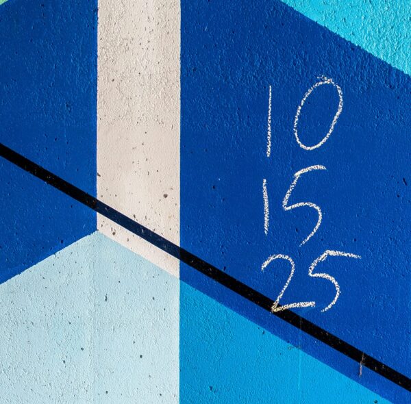 A blue background with a white stripe and three numbers written in chalk.