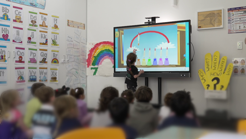 Child at Platinum Preschool using BenQ board